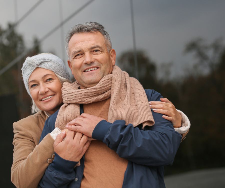 An older couple outdoors in autumn coats